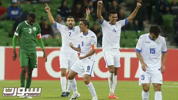 Uzbekistan's players celebrate after winning their Asian Cup Group B soccer match against Saudi Arabia at the Rectangular stadium in Melbourne